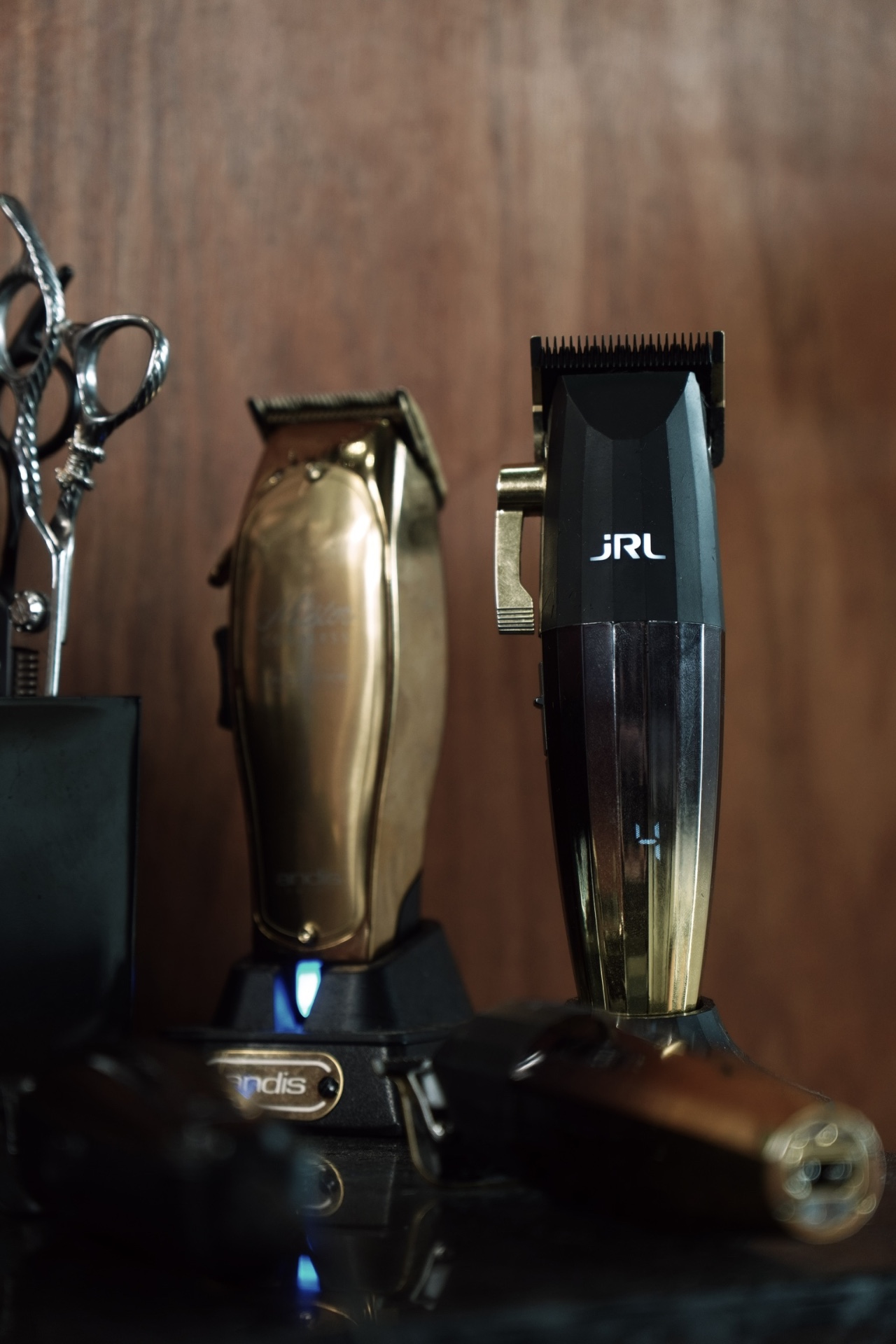 Gold Andis and JRL clippers on the bench